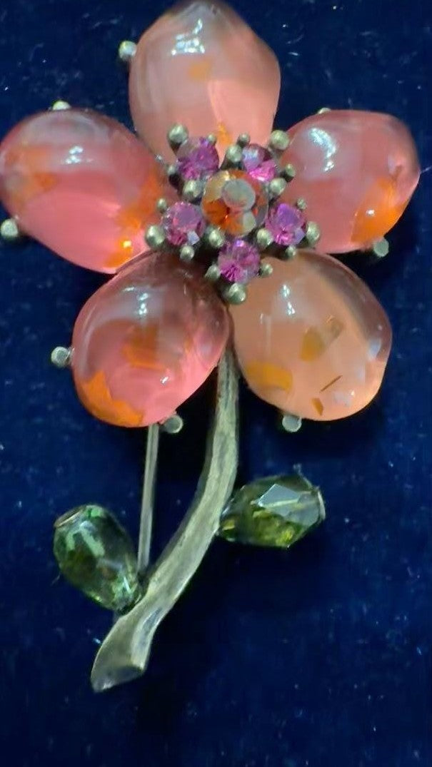 Vintage DeLizza & Elster Juliana flower brooch with translucent pink cabochon petals and fuchsia rhinestone center on blue velvet