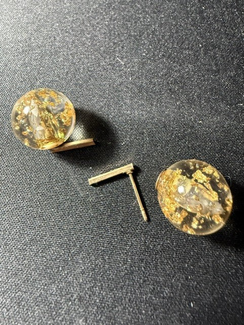 Close-up of vintage lucite dome earrings with gold foil and bar post