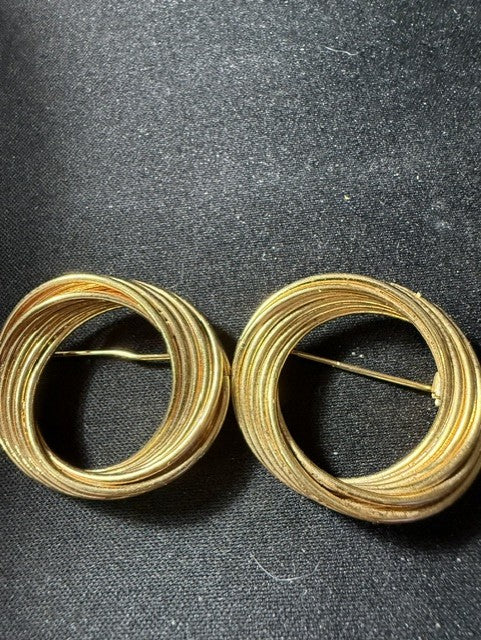 Both vintage gold-tone circular swirl brooches side by side showing matching design and condition