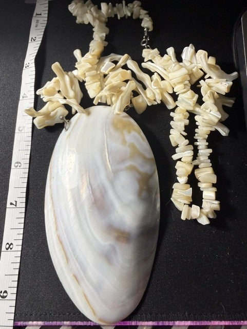 Shell pendant necklace with ruler showing 5-inch pendant length and graduated coral strand