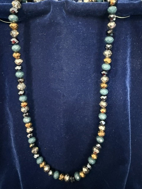 Close-up of teal natural stone and gold metallic crystal rondelle beads