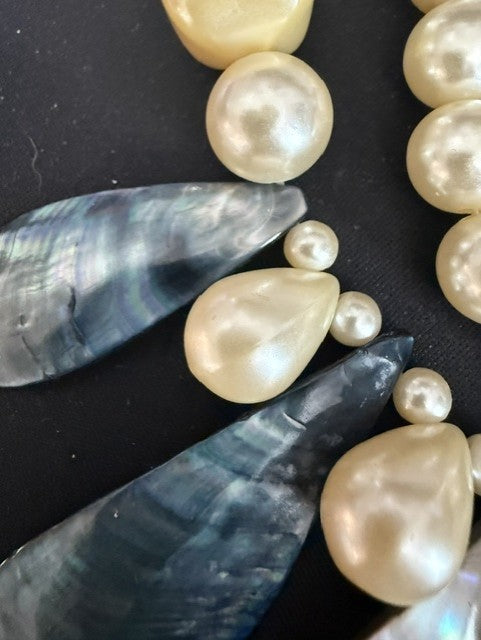 Close-up showing iridescent shell teardrops and baroque pearl detail