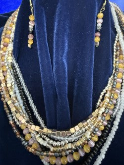 Layered multistrand beaded necklace and coordinating earrings shown from a closer angle