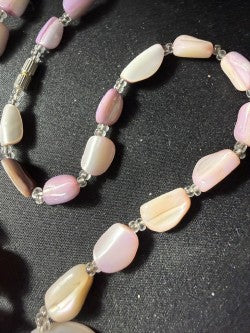 Detail of coral bead strand showing pink, lavender and cream color variation