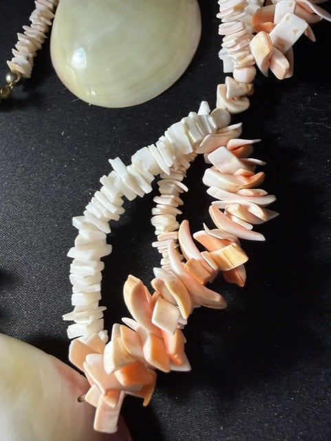 Close-up of large domed clam shell centerpiece with pink and white shell chip strands