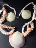 Earrings and necklace strands close-up showing domed clam shell earrings
