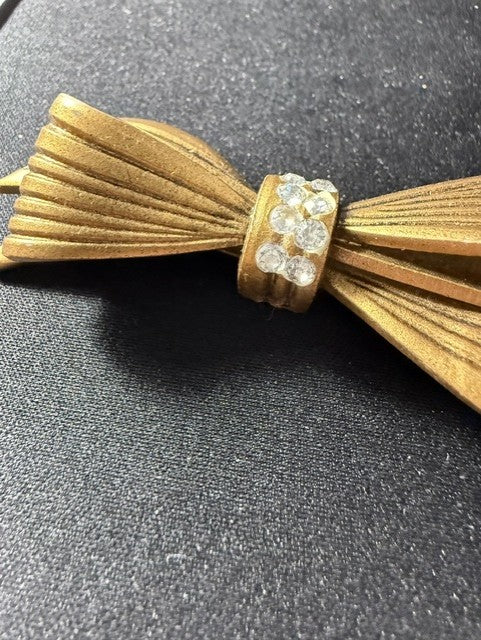 Vintage gold-tone bow brooch with rhinestones - close-up of rhinestone center