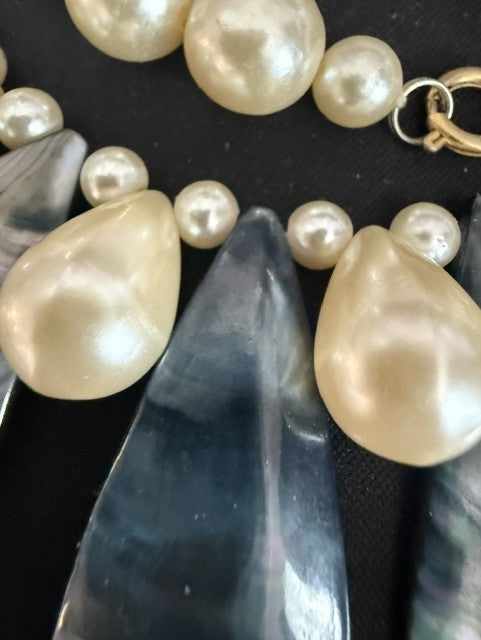 Close-up of iridescent black lip shell teardrops and baroque pearl beads