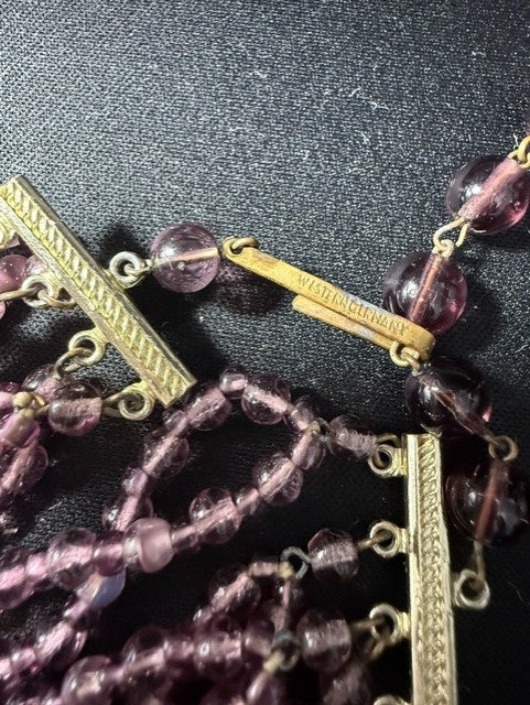 Close-up of Western Germany signed clasp on amethyst glass bead necklace