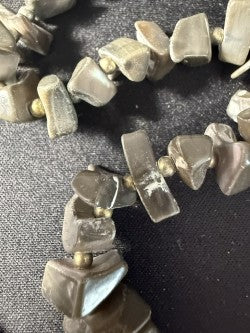 Close-up of grey branch coral chips with silver spacer beads