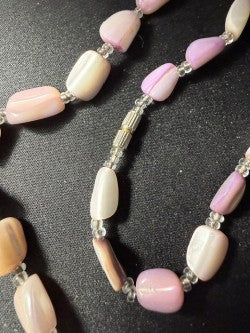 Close-up of polished coral nugget beads with clear seed bead spacers