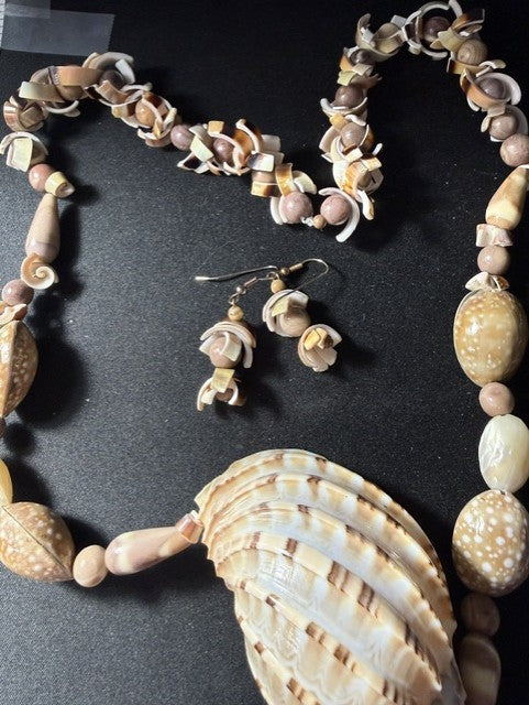Close-up of spiral snail shell beads and mixed shell beads on necklace