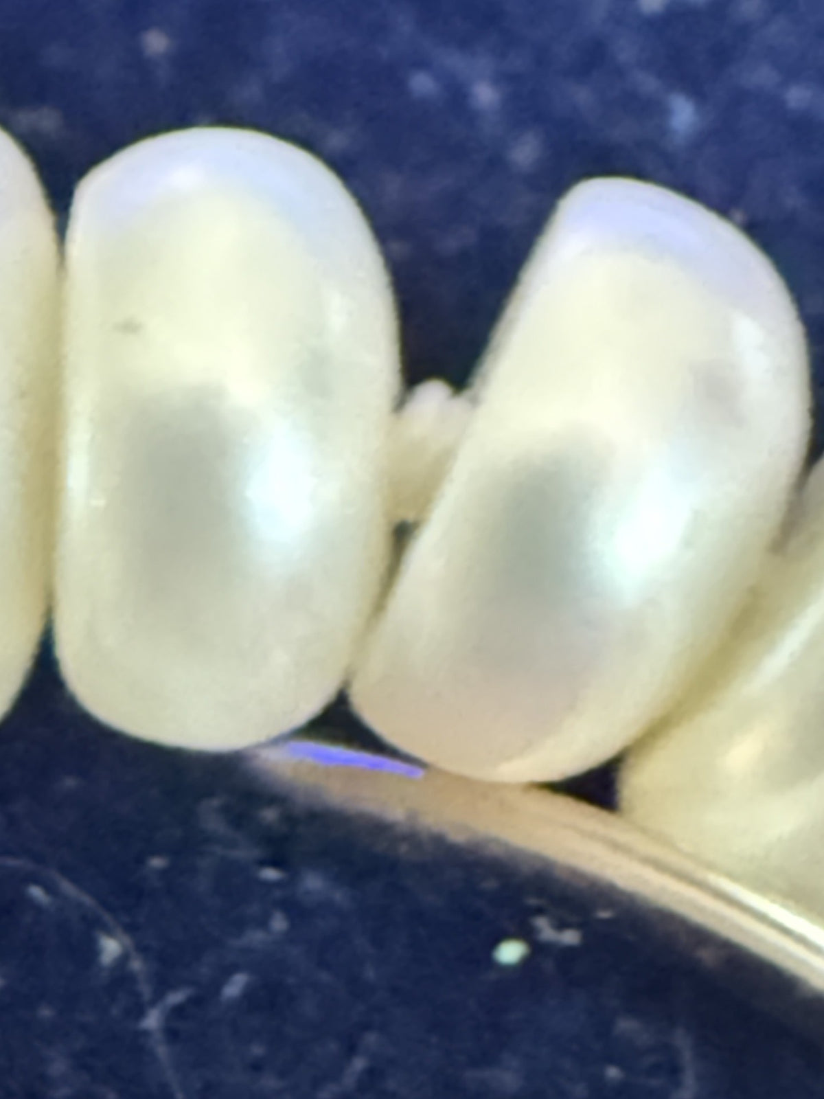 Close-up of pearl luminescence with gold clasp