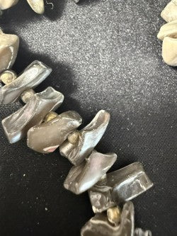 Detail shot showing natural iridescent surface of grey branch coral chips