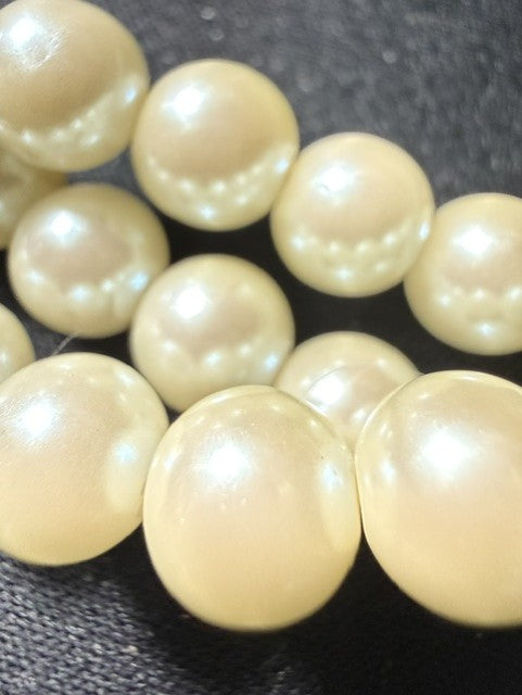 Close-up of large cream ivory faux pearl beads showing luster