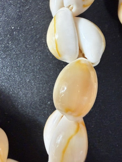 Vintage yellow cowrie shell necklace, close-up of shells