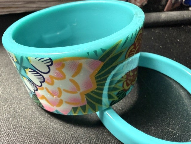 Wide teal tropical floral acrylic bangle with slim solid teal bangle, side view