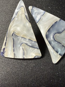 Close-up of natural shell surface showing grey, white, and lavender marbling