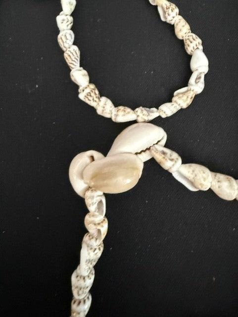 Detail showing cowrie shell accent beads on turritella strand