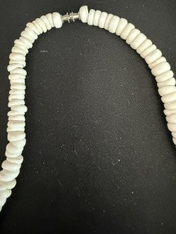 White puka disc shell necklace showing silver barrel clasp