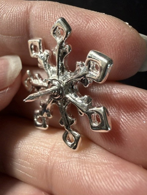 Vintage sterling silver snowflake pin side detail in hand