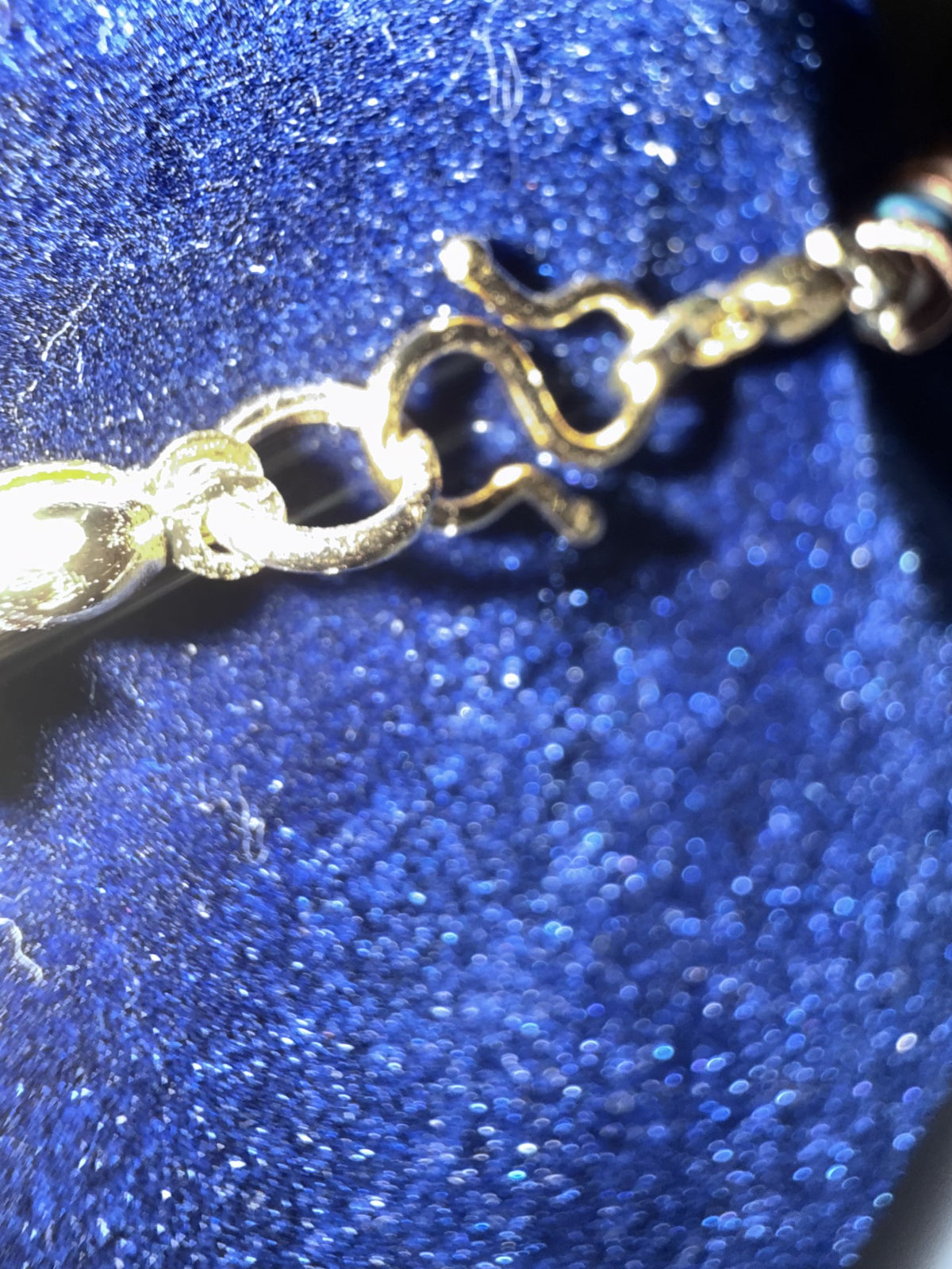 Gold-plated S-clasp detail