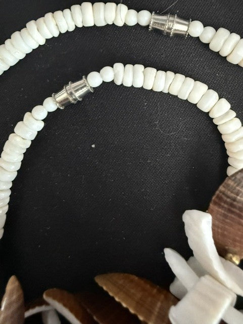Detail of white disc bead strand and silver barrel clasp