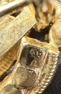 Close-up of Trifari signature mark on brooch