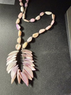 Full necklace showing shell petal fringe centerpiece and coral bead strand