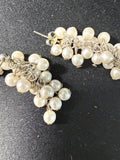 Vintage seed pearl cluster drop earrings on dark fabric