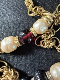 Close-up of baroque pearl and garnet glass bead detail