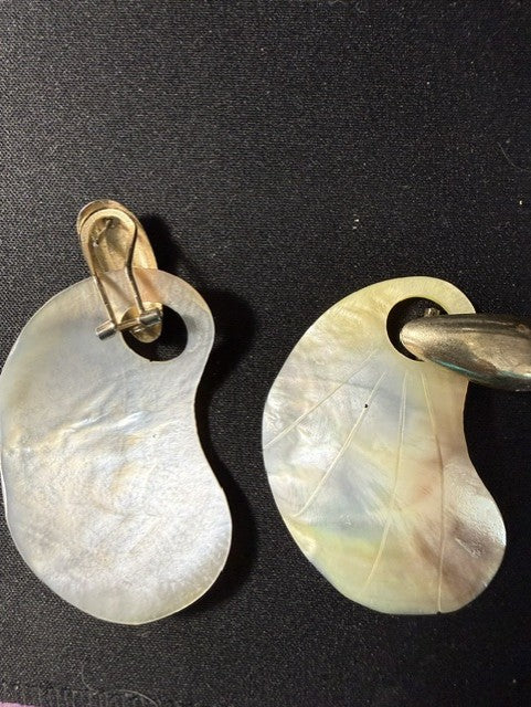Back view of vintage mother-of-pearl clip-on earrings showing gold-tone clip findings