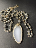 White druzy agate slice pendant necklace with gold-dipped edges and crystal bead chain