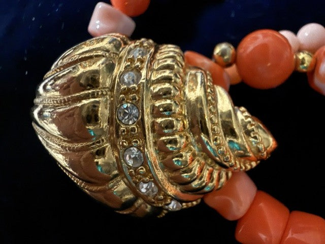 Close-up of ornate gold-tone rhinestone and enamel barrel clasp on KJL Avon necklace