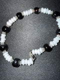 Black and white puka shell bead bracelet with silver spacers