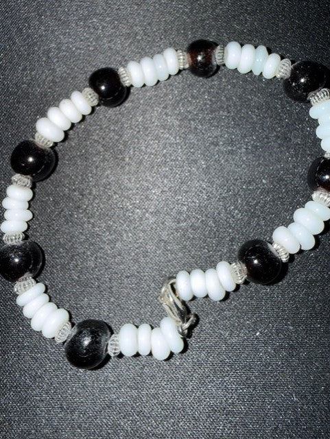 Black and white puka shell bead bracelet with silver spacers