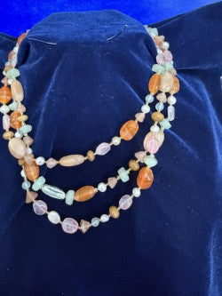 Detail shot showing pearl and rose quartz strands with gold spacers