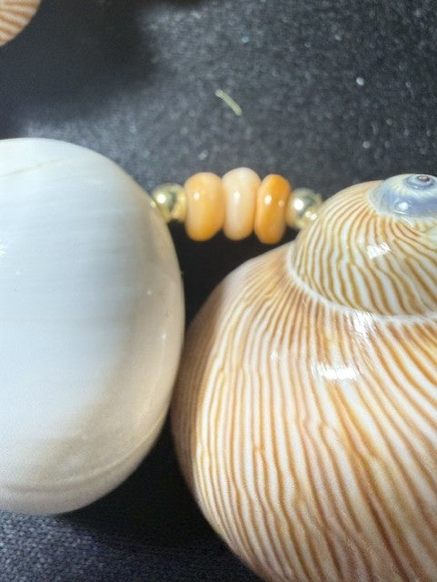 Detail showing white moon shell and striped brown shell with peach rondelle and gold bead spacers