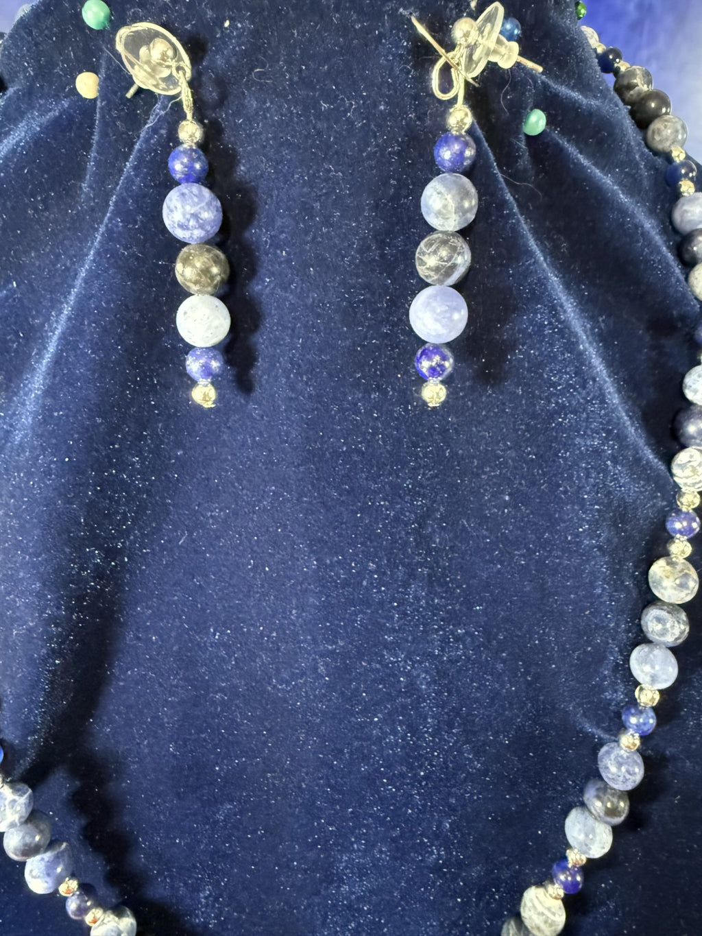Matching drop earrings and necklace bead details with silver-plated accents