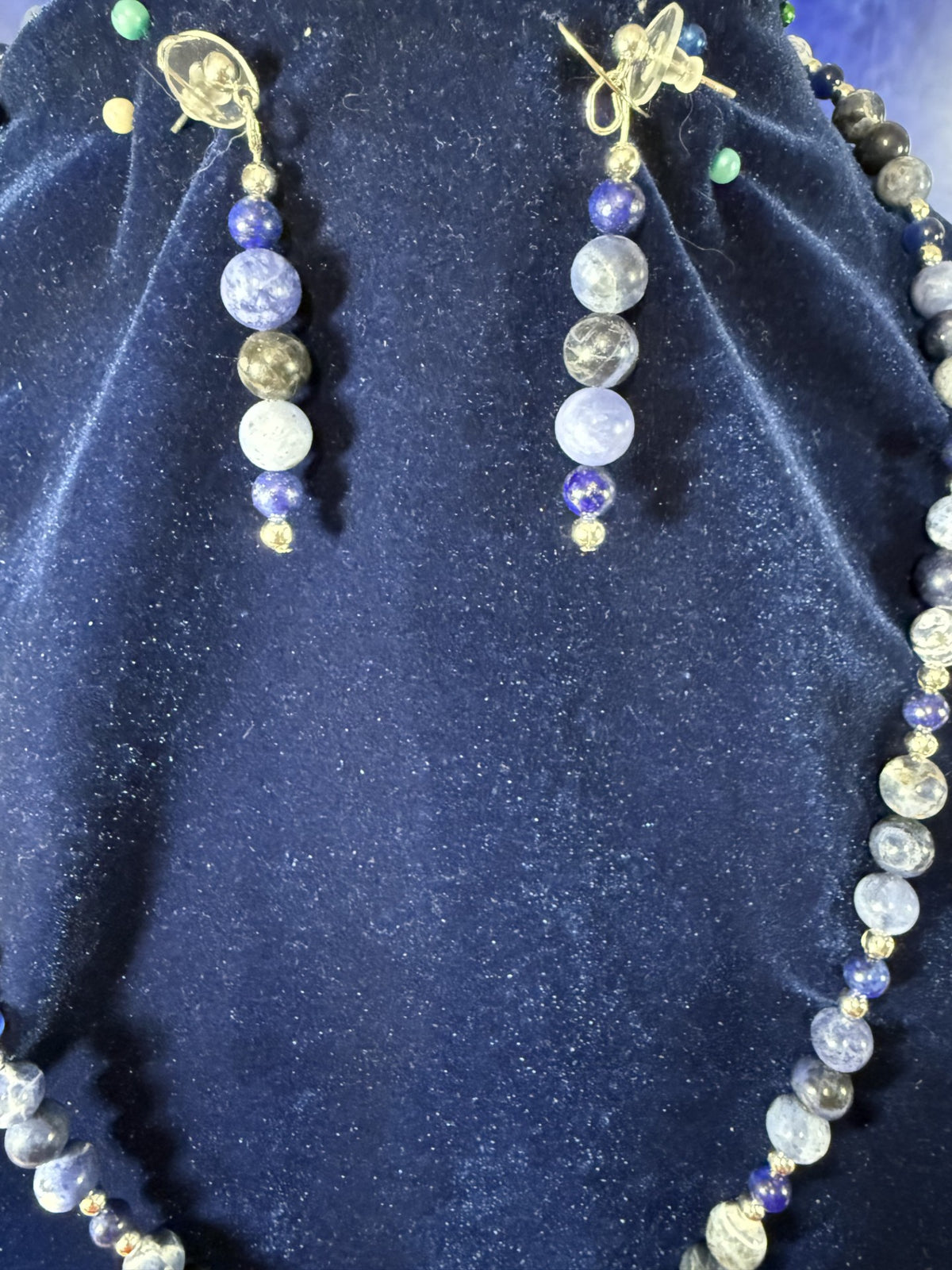 Matching drop earrings and necklace bead details with silver-plated accents