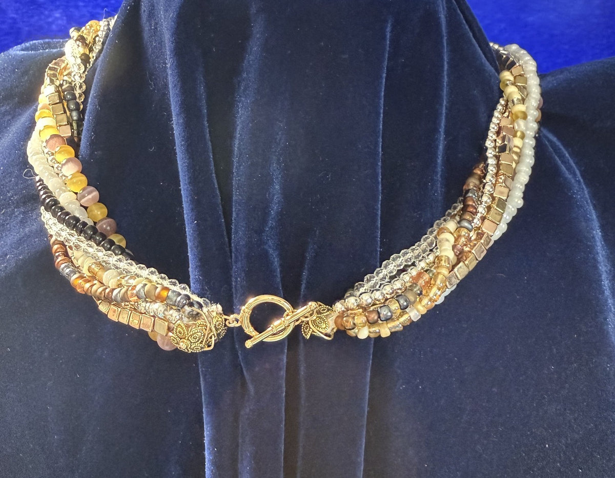 Gold-plated toggle clasp and decorative end pieces on the multistrand beaded necklace