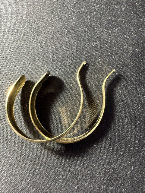 Back view of gold-tone half-hoop earrings showing post closure