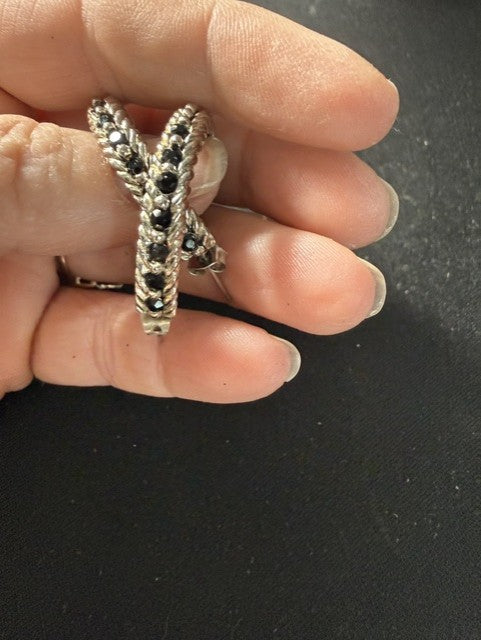 Close-up of black gemstone channel and twisted rope detail on hoop earrings