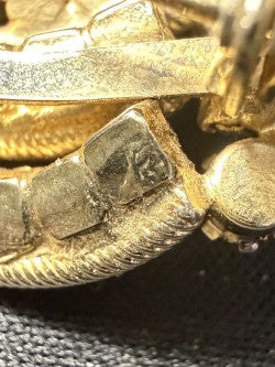 Close-up detail of Trifari rhinestone swirl brooch