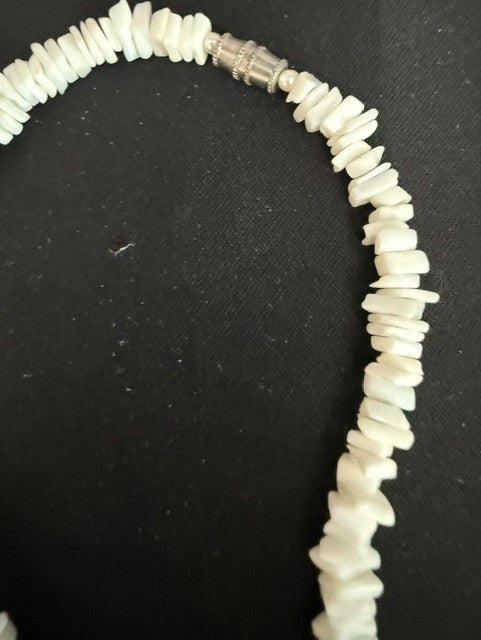 Detail of silver barrel clasp on white shell chip necklace