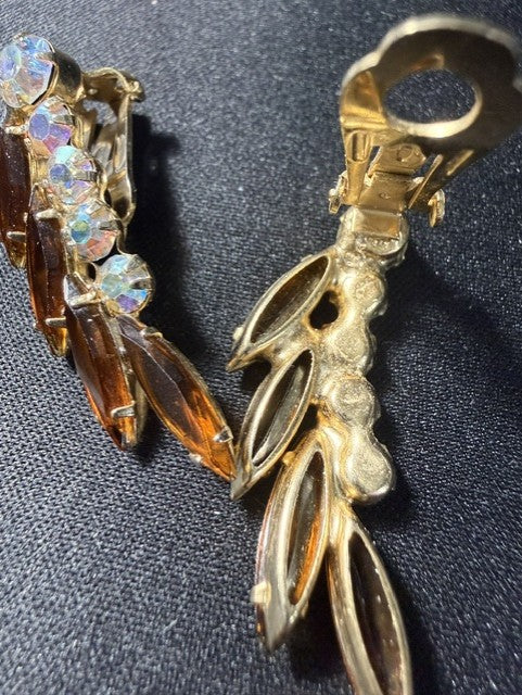 Close-up of filigree back detail on vintage amber rhinestone clip-on earrings