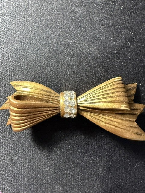 Vintage gold-tone celluloid bow brooch with rhinestones - full front view