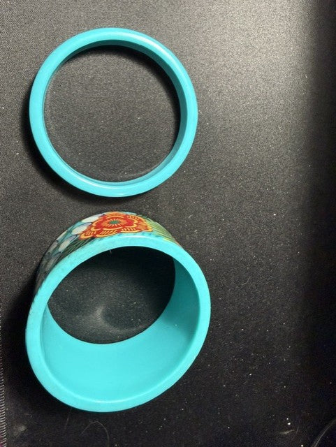 Teal floral and solid bangle set laid flat showing both pieces