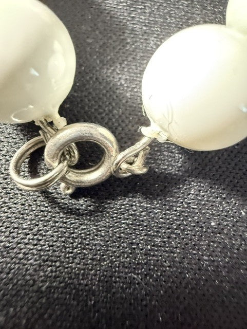 Close-up of white howlite beads and silver-tone spring ring clasp