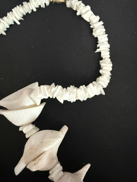 View of silver barrel clasp and shell chip strand